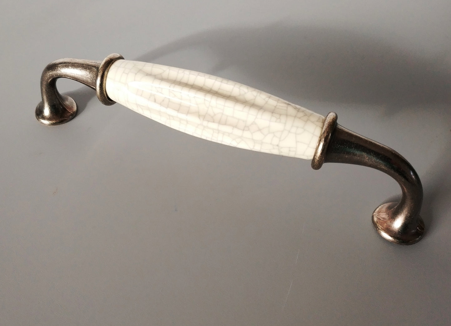 Metal-porcelain furniture handle, available in several colors