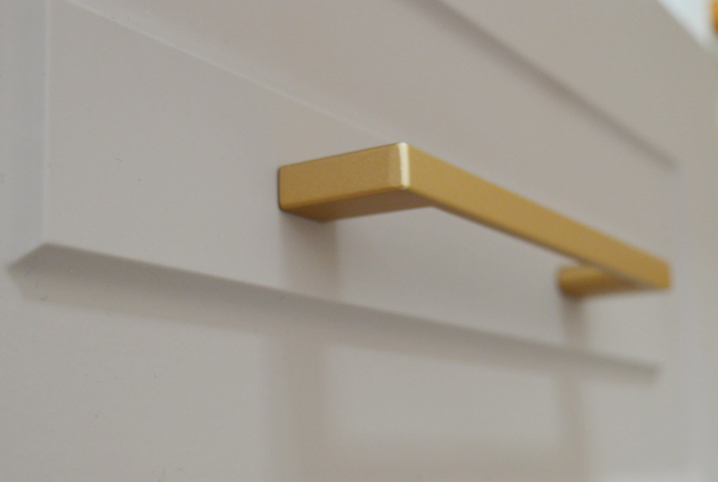 Metal furniture handle, matt gold color, with a unique textured surface