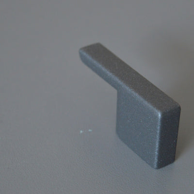 Metal furniture handle, anthracite gray color, with a unique textured surface