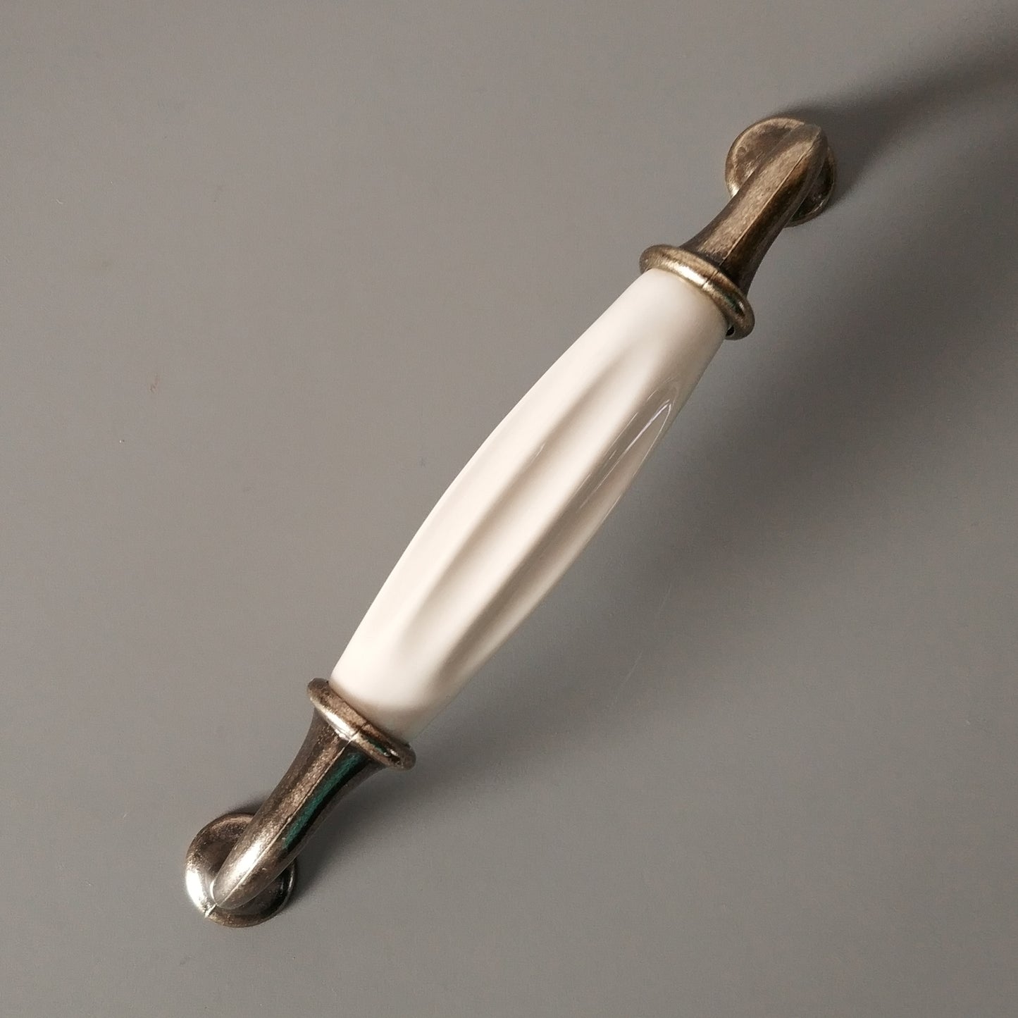 Metal-porcelain furniture handle, available in several colors