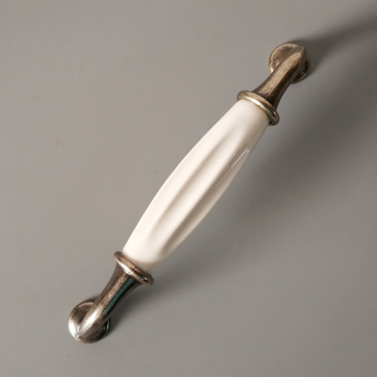 Metal-porcelain furniture handle, available in several colors