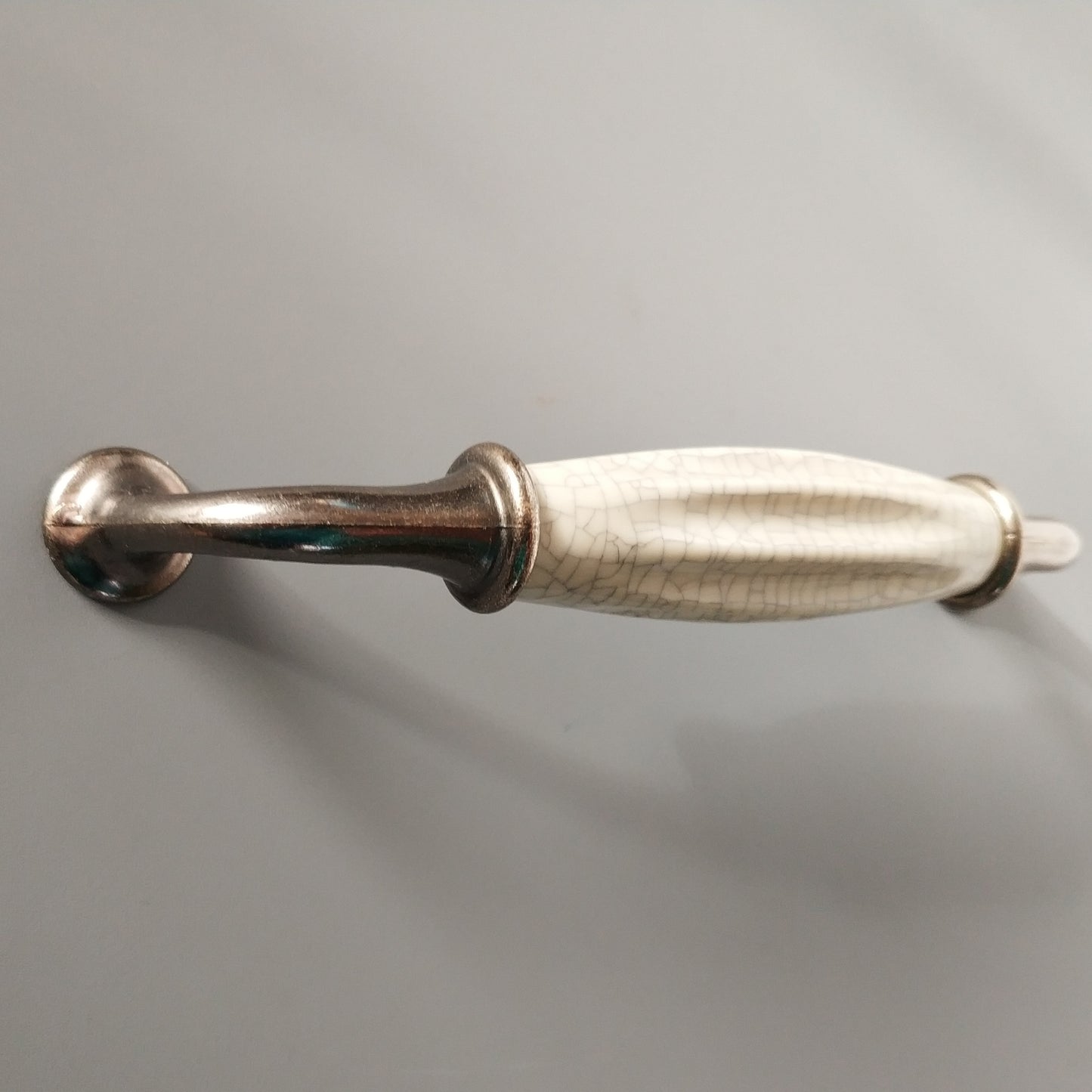 Metal-porcelain furniture handle, available in several colors