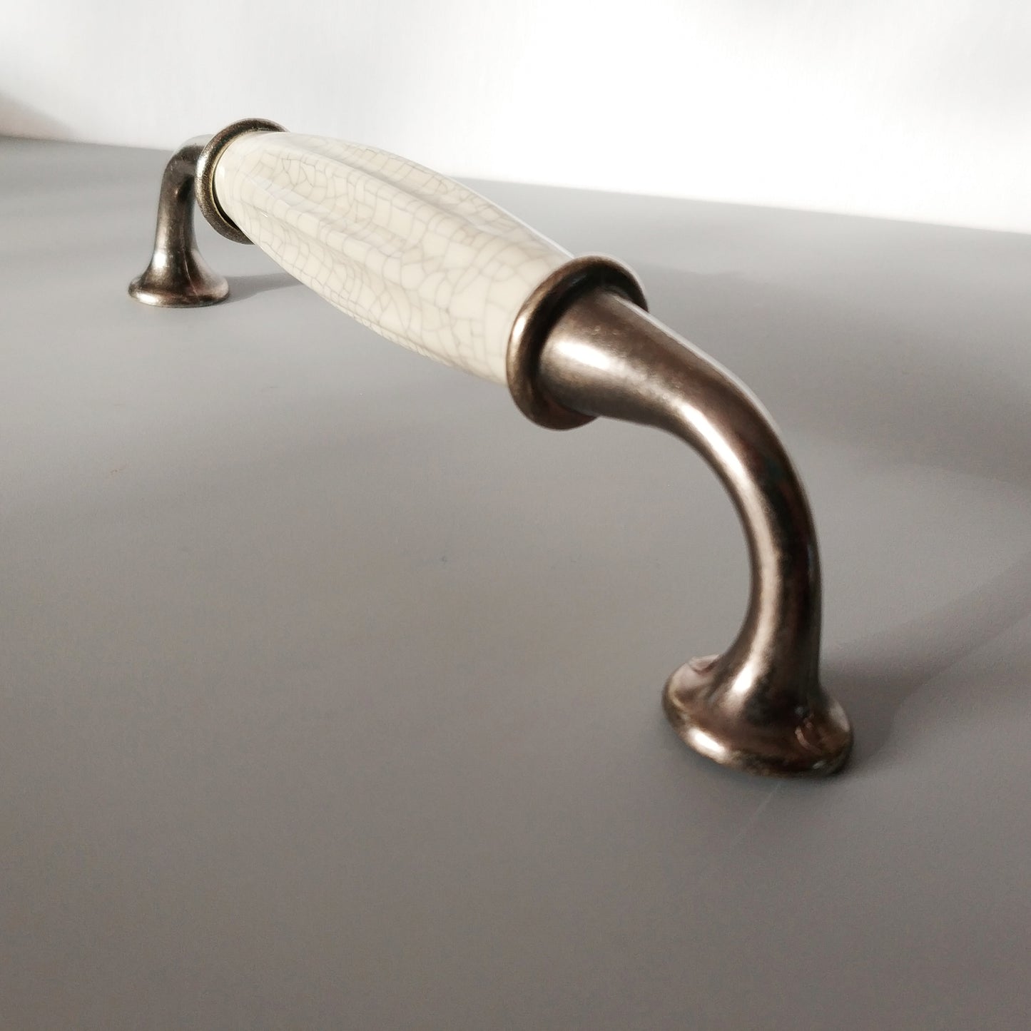Metal-porcelain furniture handle, available in several colors
