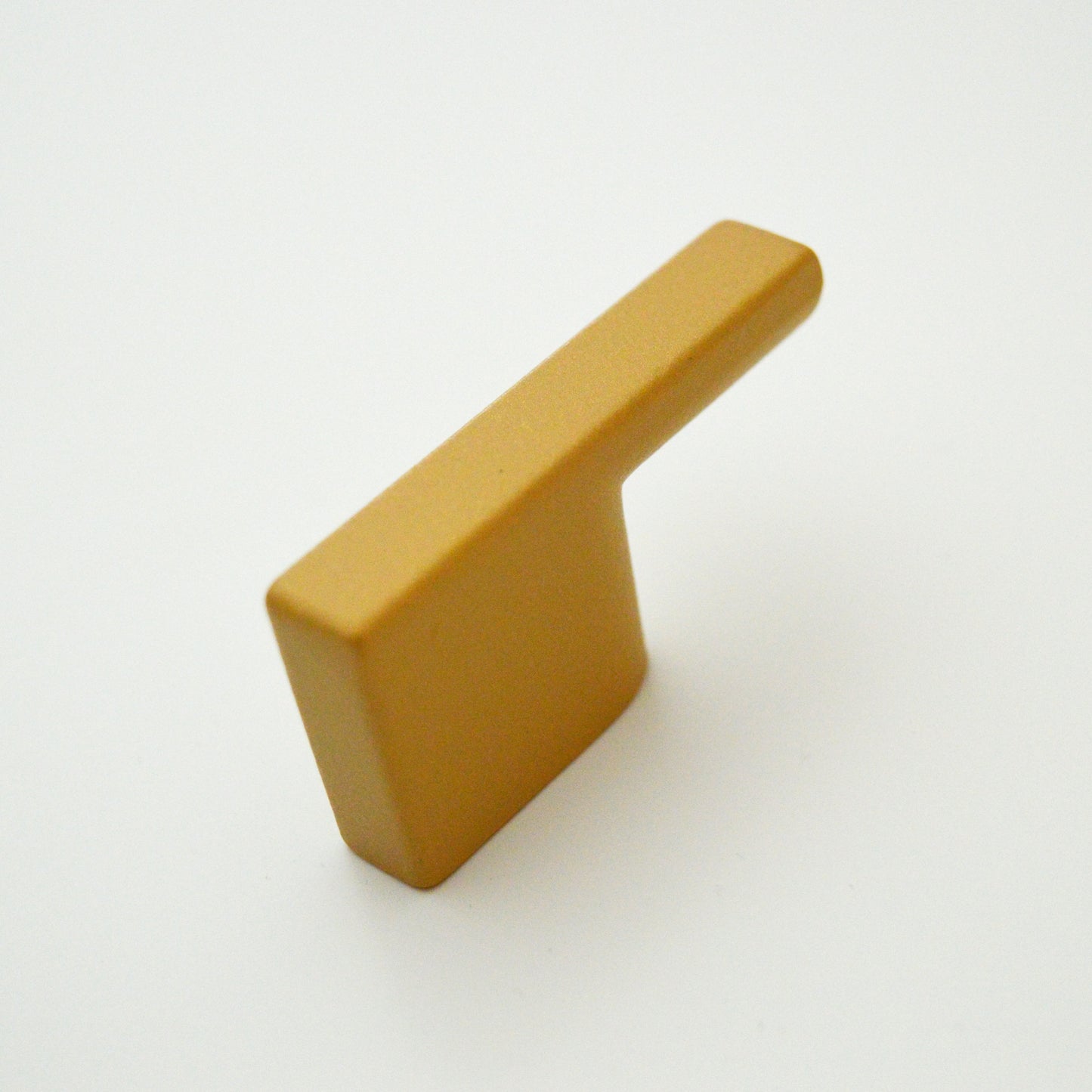 Metal furniture handle, matt gold color, with a unique textured surface