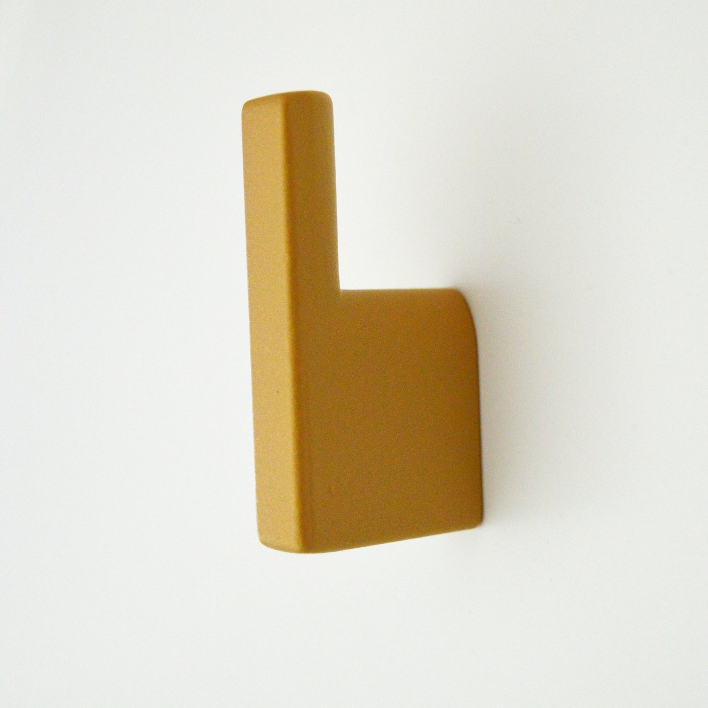 Metal furniture handle, matt gold color, with a unique textured surface